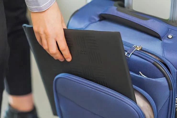 Folded Travel Ledge being packed into rolling luggage